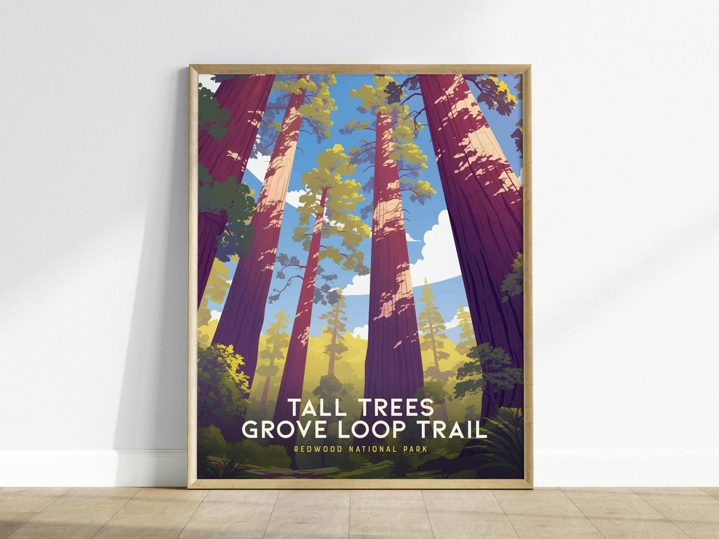 Framed poster of a forest scene with 'Tall Trees Grove Loop Trail' text on a white wall.