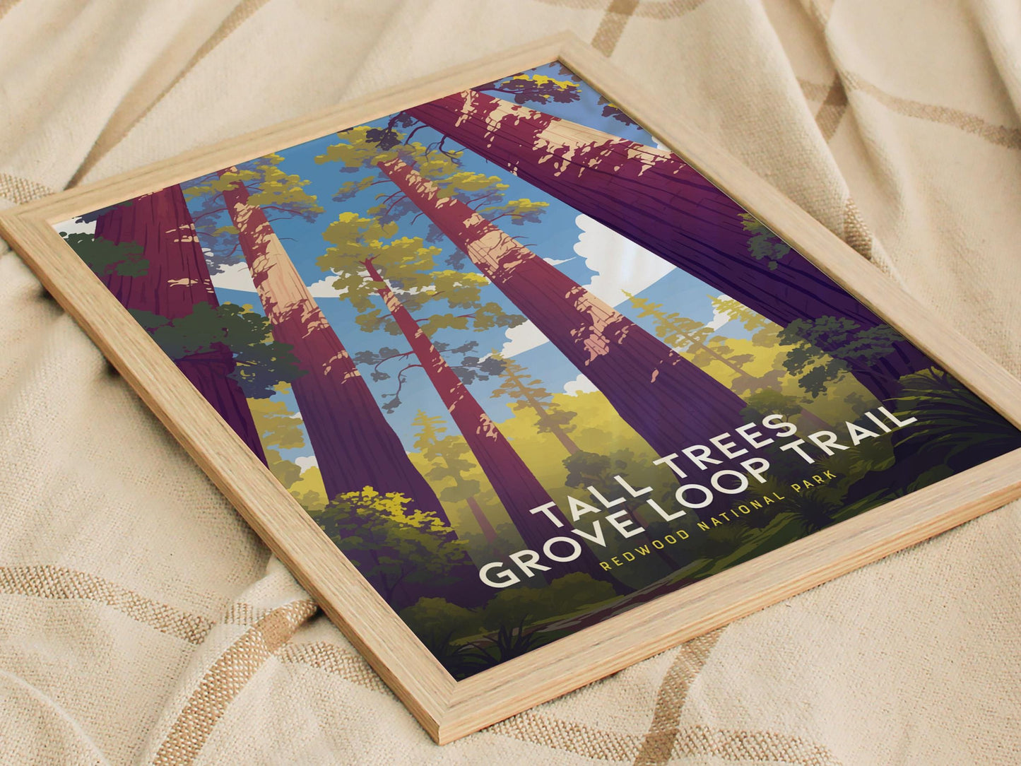 Framed poster of Tall Trees Grove Loop Trail with trees and text on a beige fabric background