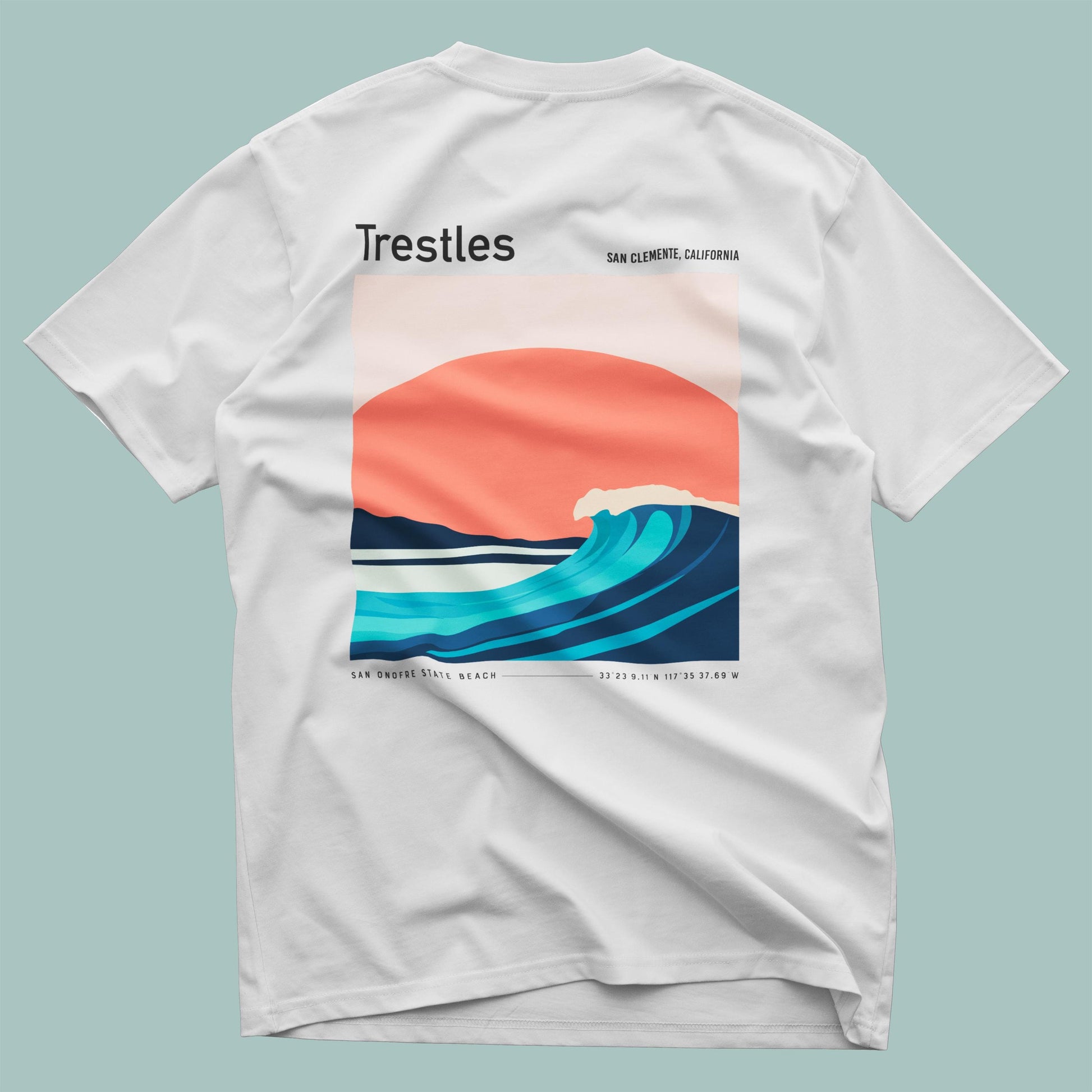 White t-shirt with a wave design and 'Trestles' text on a light blue background
