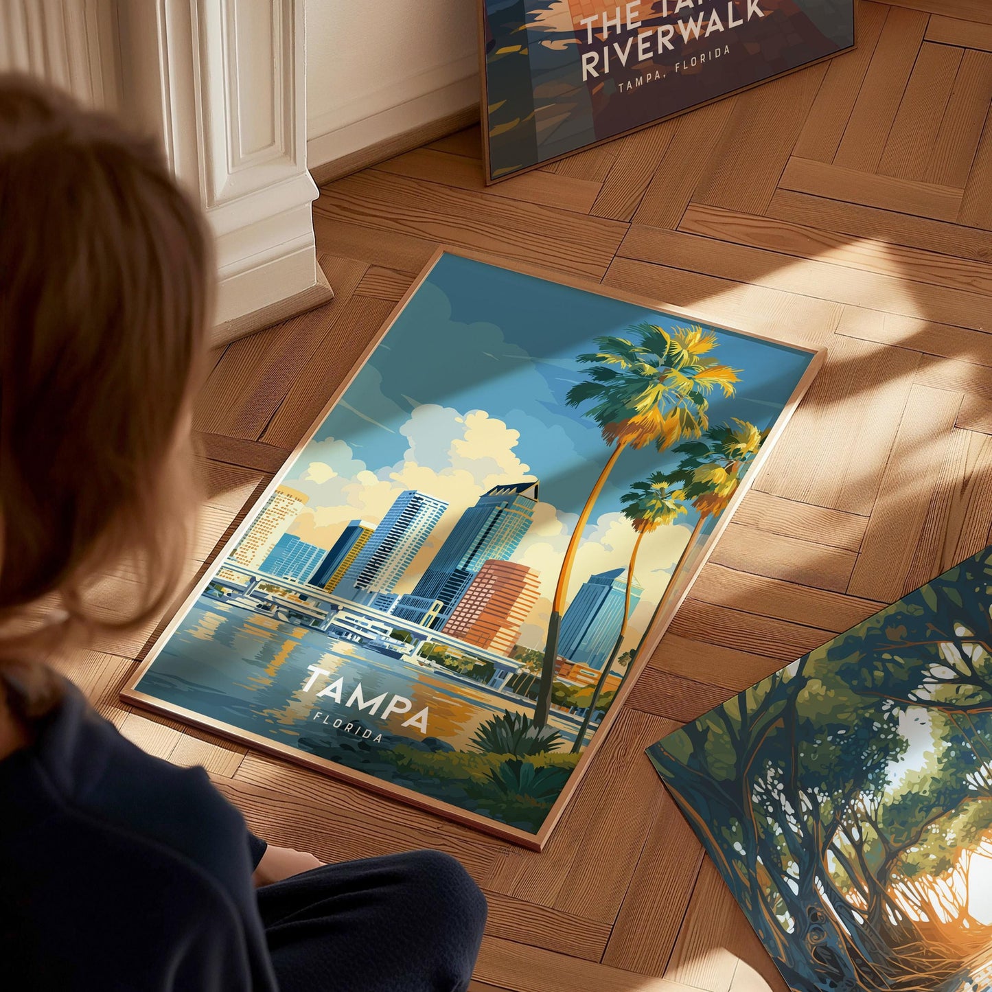 Person looking at a poster of Tampa, Florida with a cityscape design on a wooden floor.