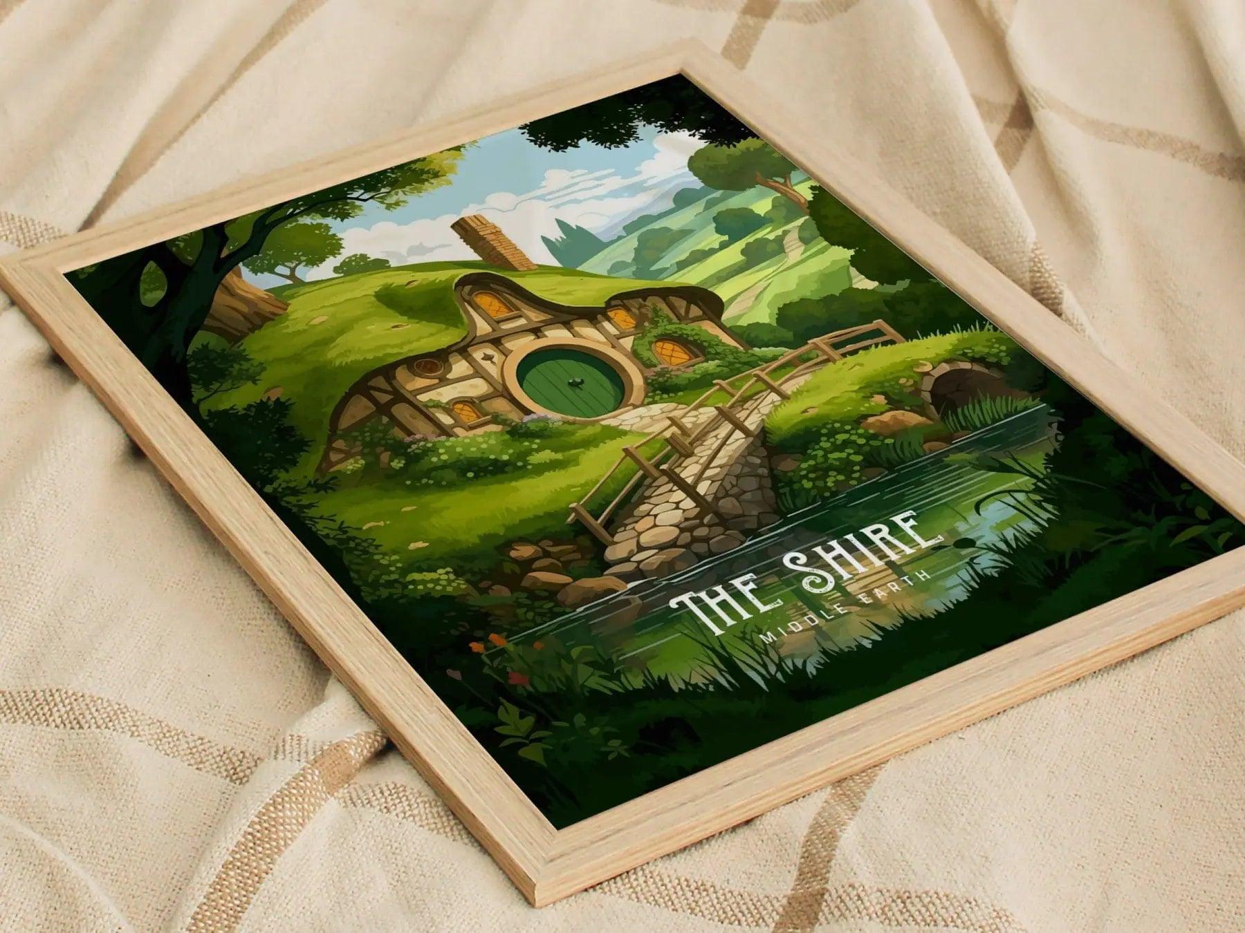 Framed artwork of a hobbit house with 'The Shire' text on a textured fabric background