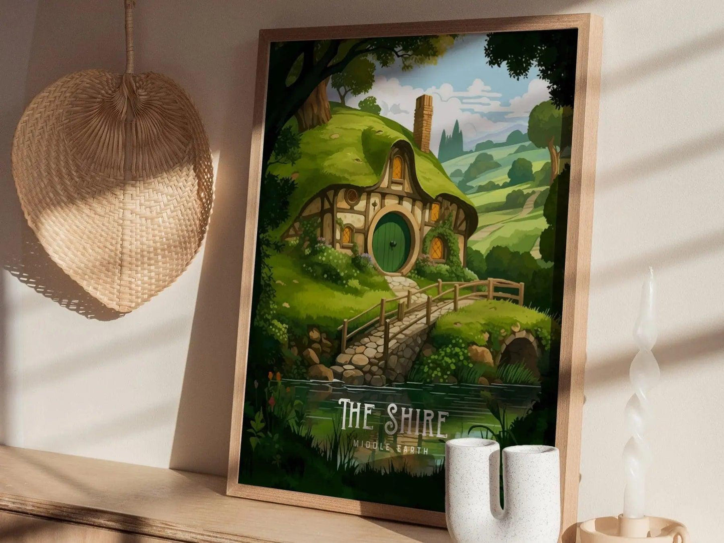 Framed artwork of 'The Shire' from 'The Lord of the Rings' on a wall.
