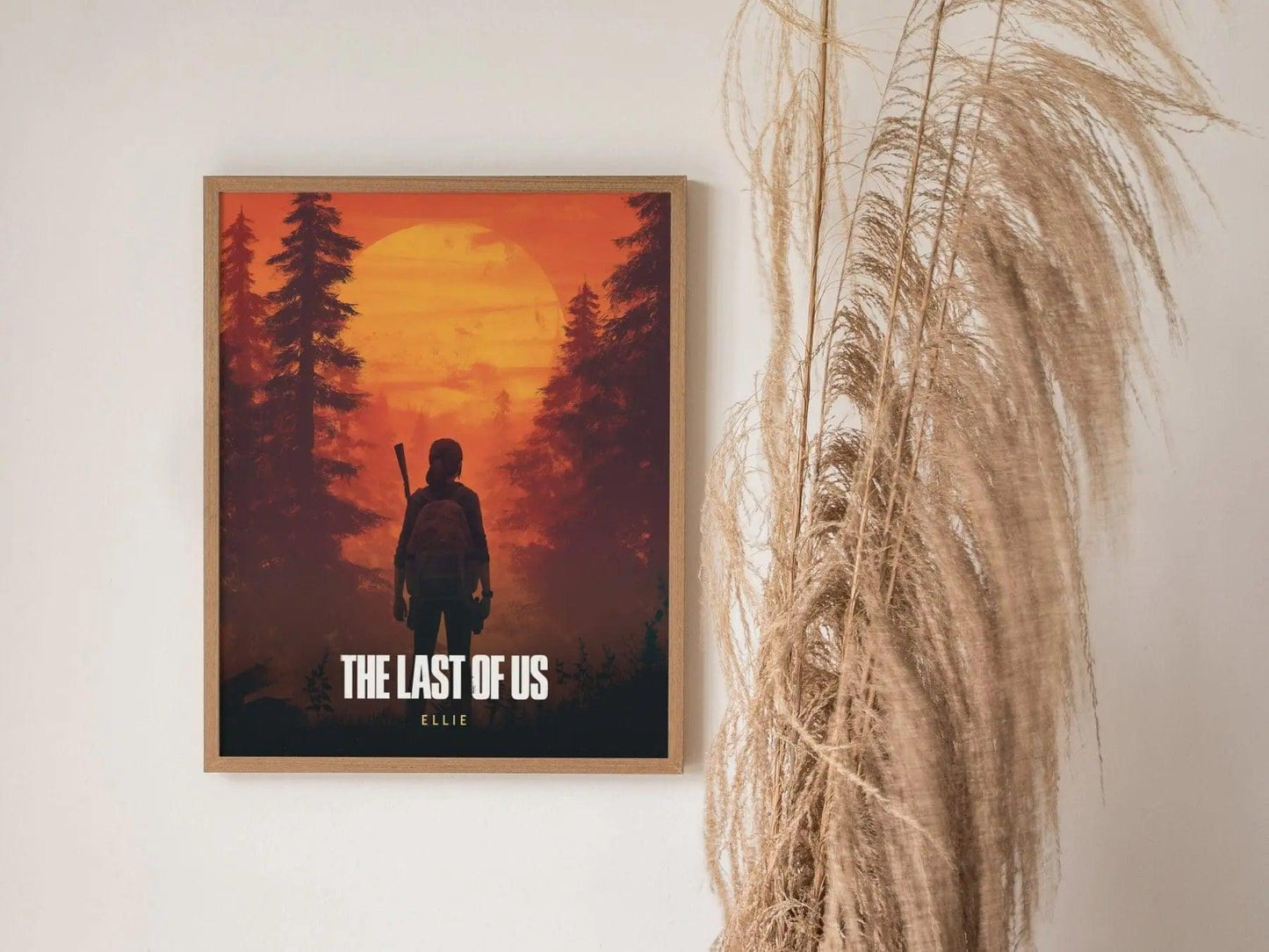 Framed 'The Last of Us' poster with silhouette of a character against a sunset forest background.