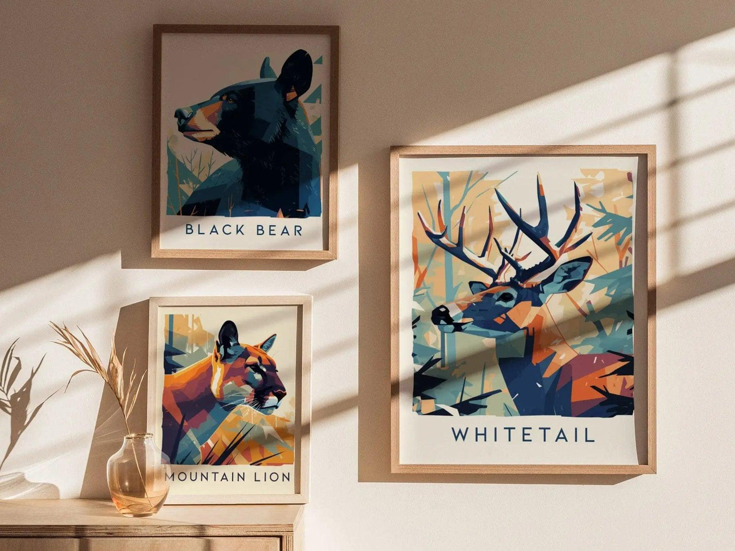Framed animal art prints of a black bear, mountain lion, and whitetail deer on a wall.