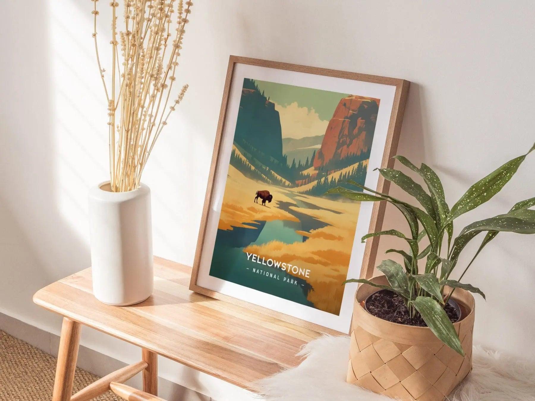 Framed Yellowstone National Park poster on a wooden table with plants and a vase.