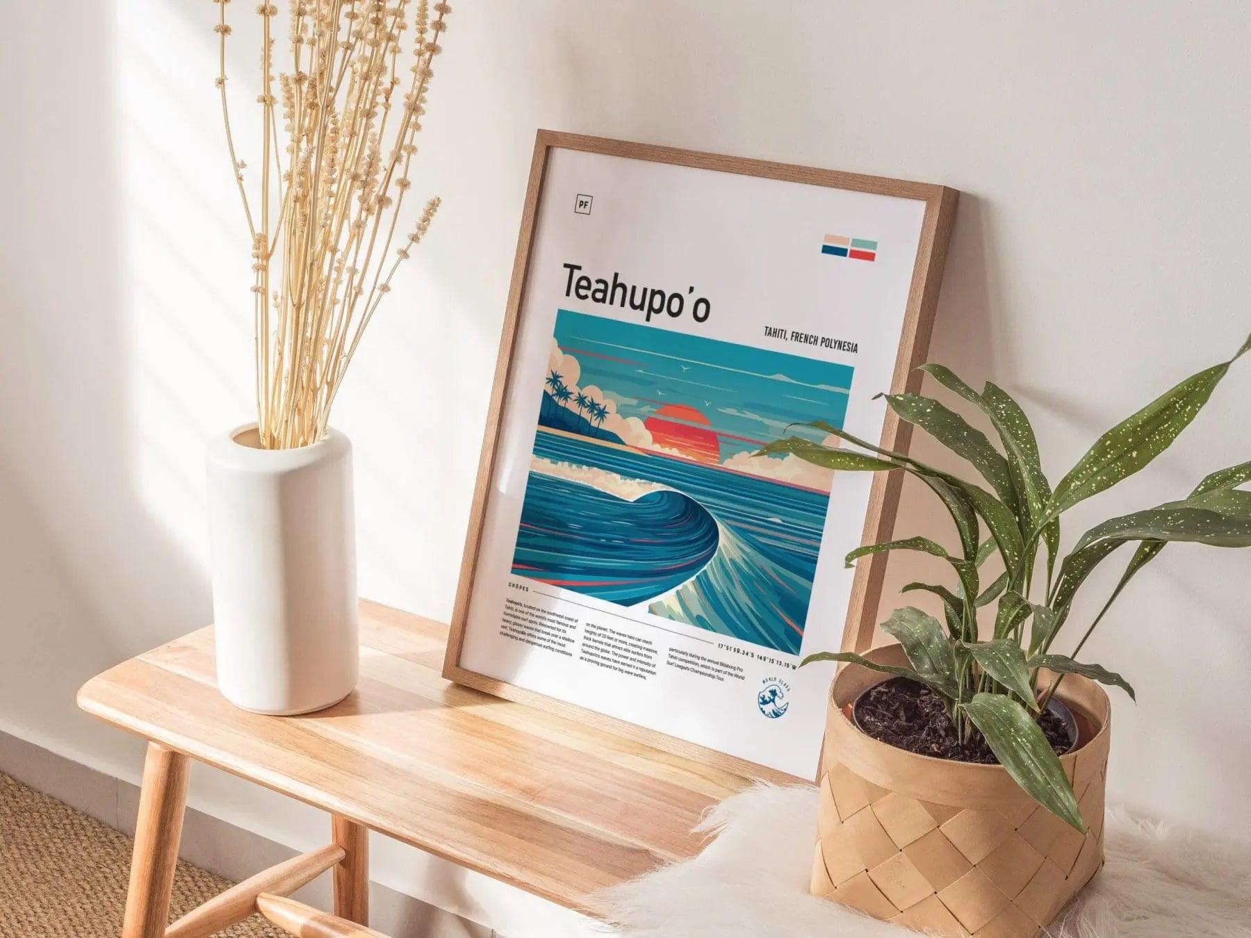Framed poster of Teahupo'o on a wooden table with plants and a vase.