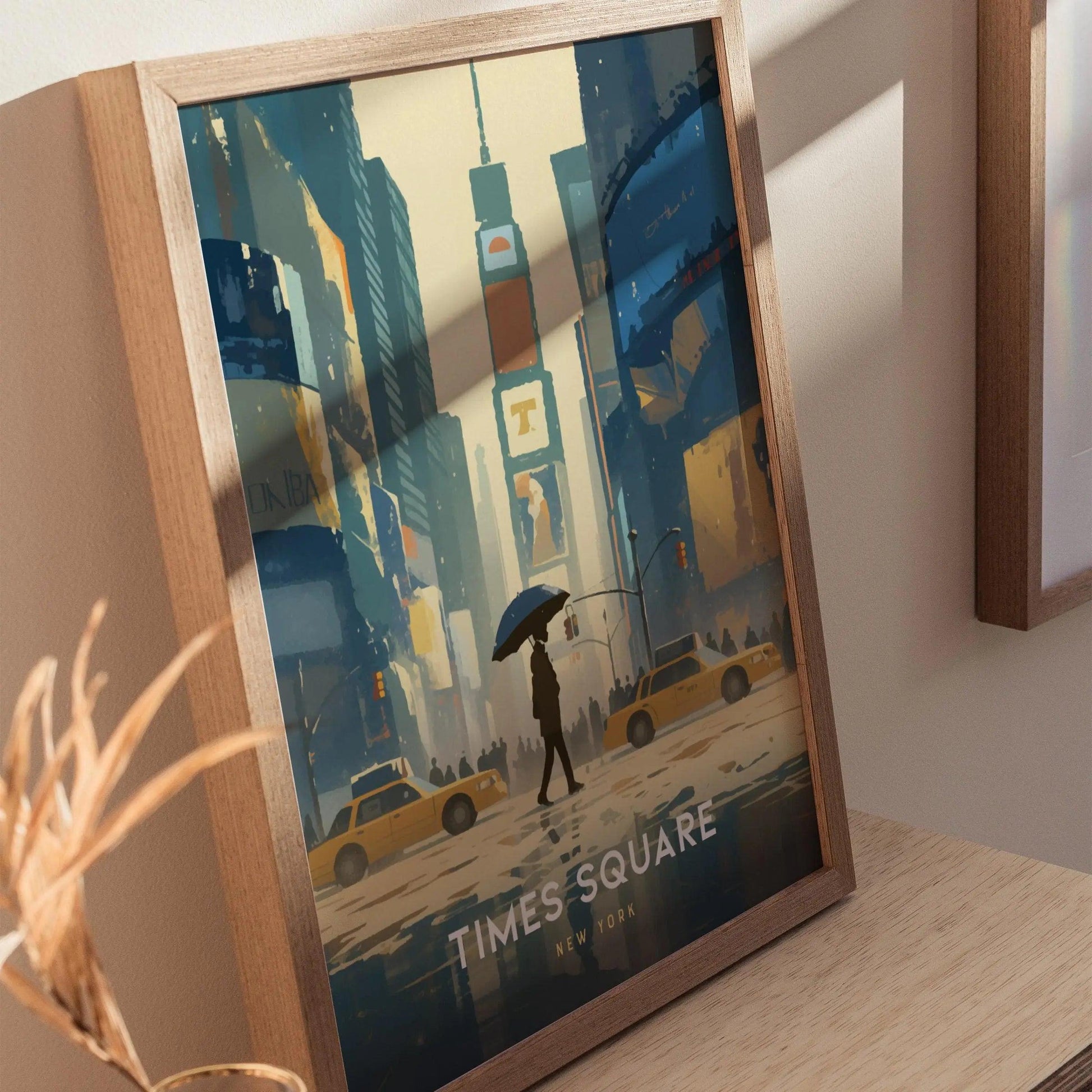 Framed artwork of Times Square with a person holding an umbrella and yellow taxis.