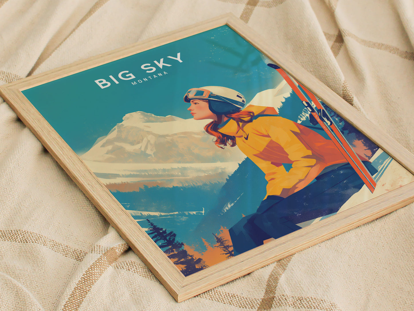 A framed poster featuring a skier in an orange jacket and helmet, sitting on a snowy mountain with skis nearby, titled Big Sky Montana against a blue sky backdrop.