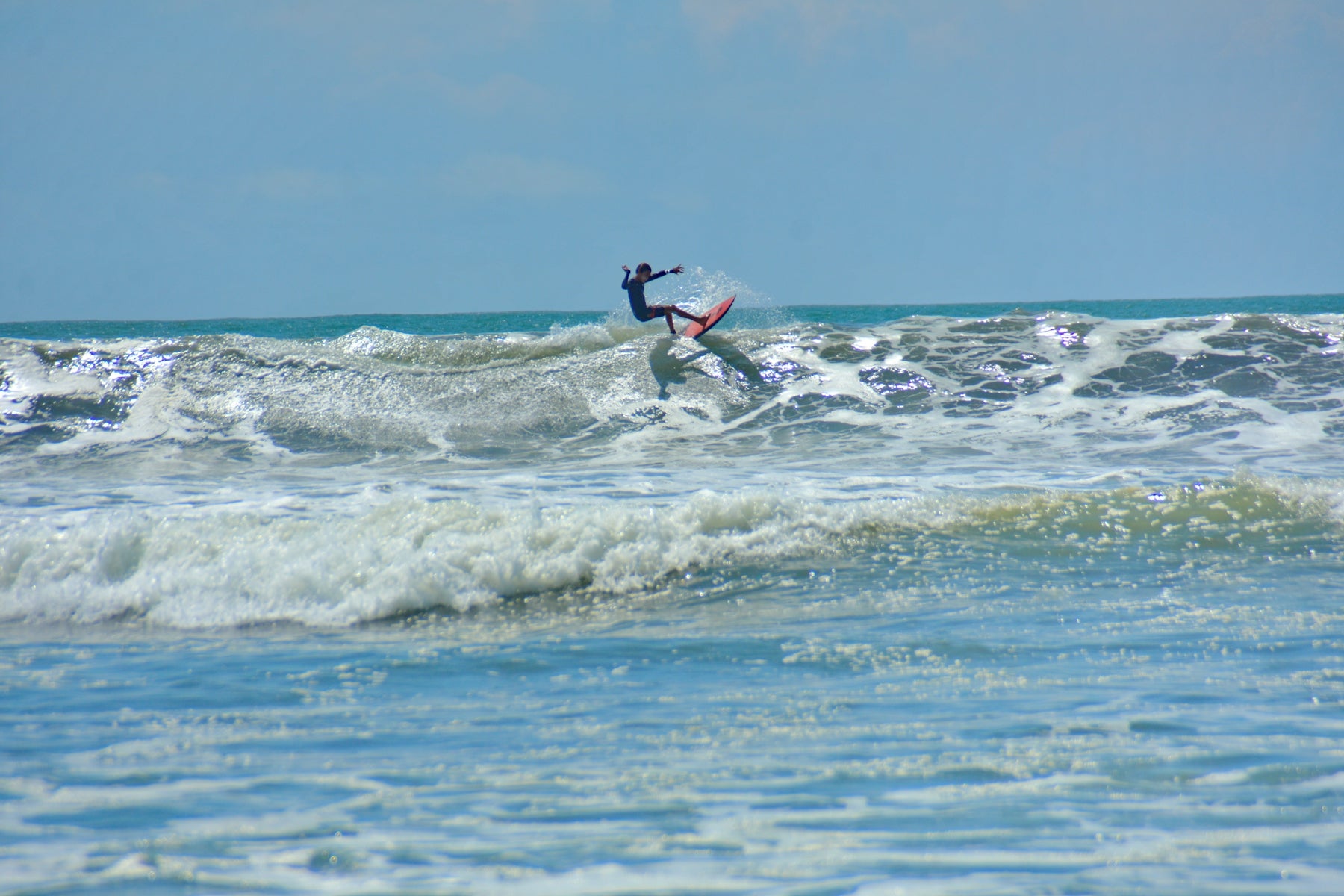 man surfing on sea waves during daytime