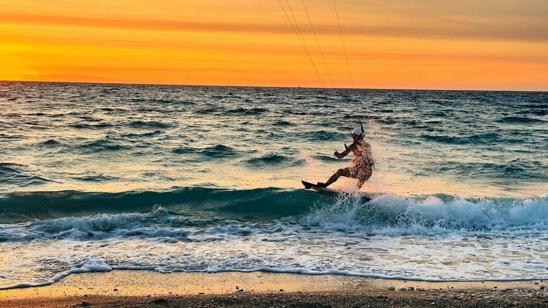 a man riding a kiteboard on top of a wave in the ocean