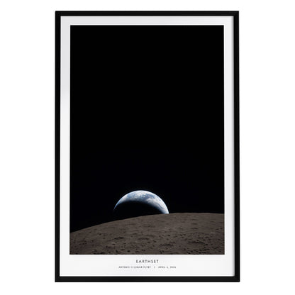 A framed poster featuring a view of Earth rising above the lunar surface, with a dark, starry background. The poster is titled Earthset and includes the text Artemis II Lunar Flyby | April 2, 2024 at the bottom.