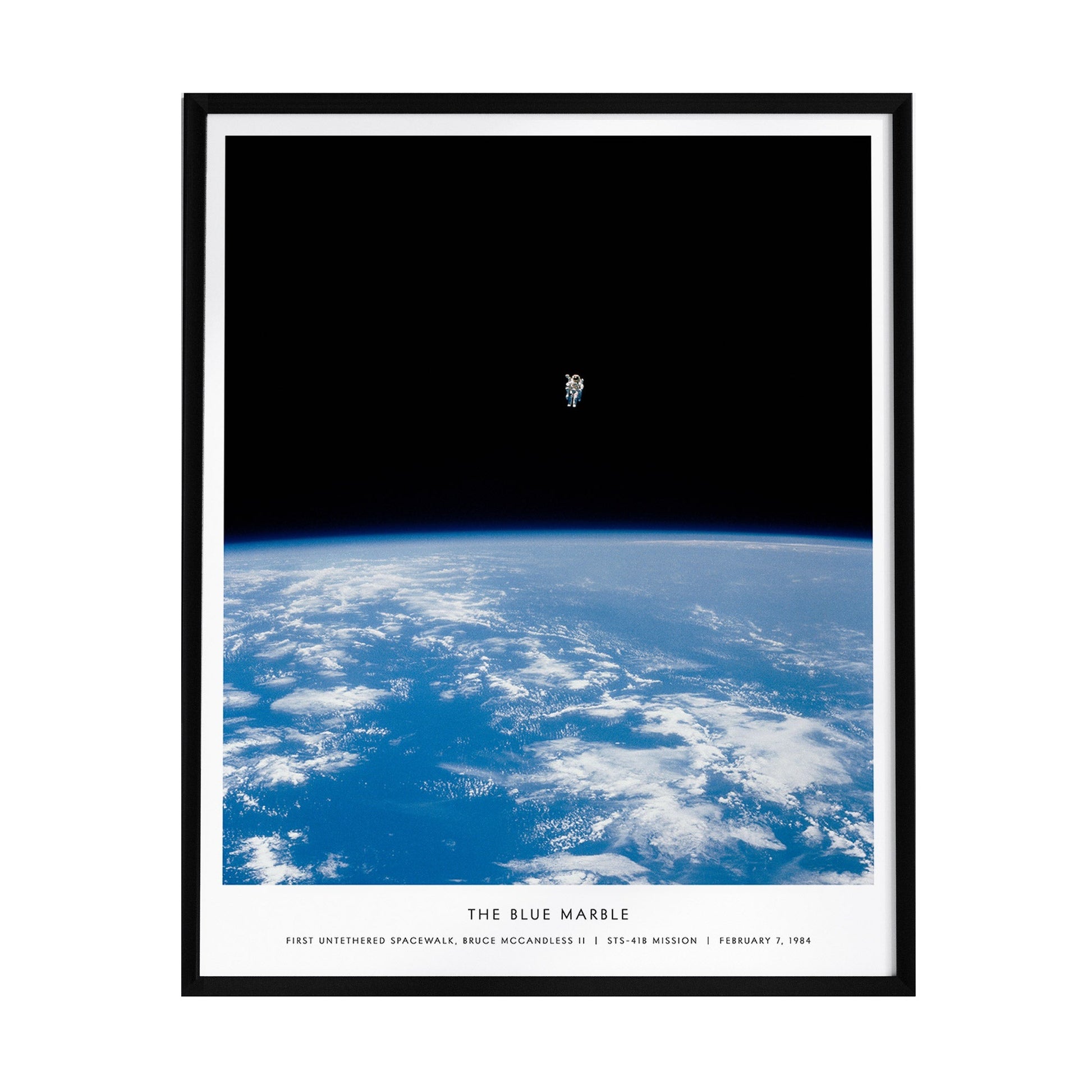 A framed poster titled The Blue Marble showcases a stunning view of Earth from space, featuring vibrant blue oceans and white clouds against a dark backdrop.