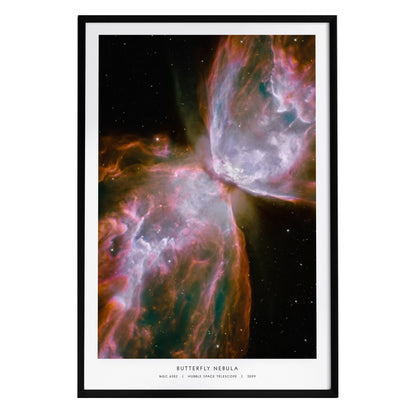 A framed poster of the Butterfly Nebula, showcasing vibrant hues of pink, orange, and purple against a dark cosmic background.