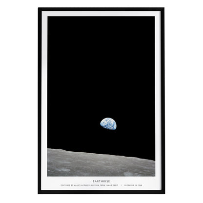 A framed poster titled Earthrise displays the iconic view of Earth rising above the lunar horizon, captured during the Apollo 8 mission. The dark background highlights the fragile blue planet against the stark lunar surface.