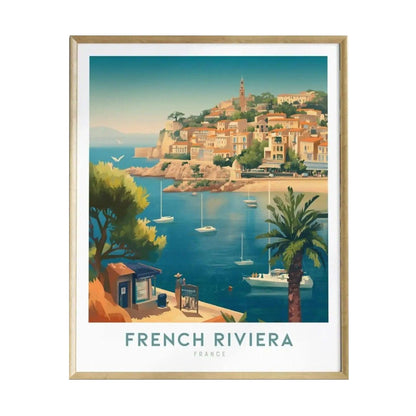 A beautifully framed poster depicting the scenic French Riviera, showcasing vibrant coastal buildings nestled on a hillside, palm trees, and sailboats anchored in clear turquoise waters.