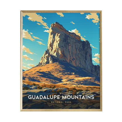 A framed poster of the Guadalupe Mountains showcases a vibrant illustration of a prominent rock formation against a backdrop of blue skies and fluffy clouds.