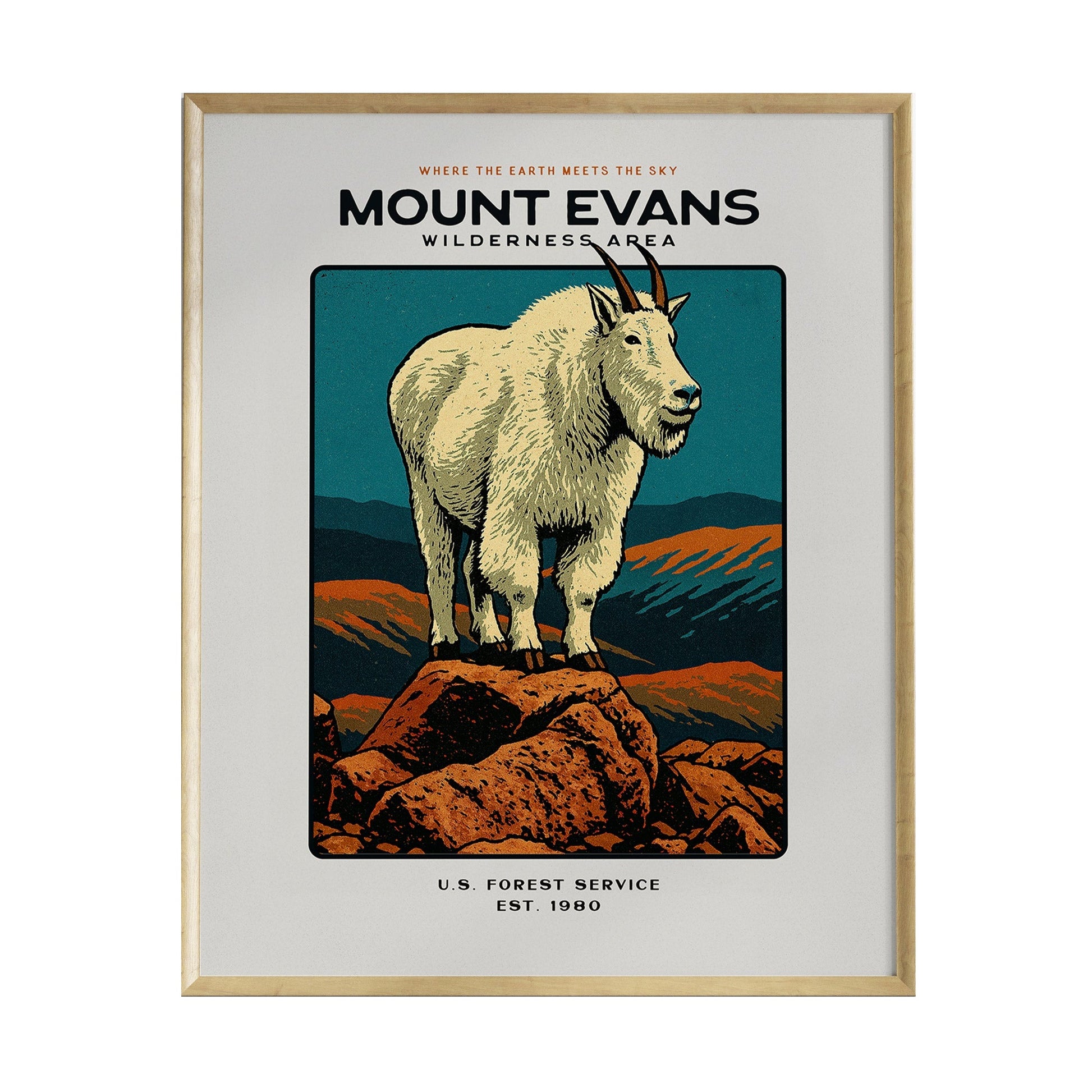 A framed poster featuring a stylized illustration of a mountain goat standing on a rocky outcrop, set against a backdrop of mountains and a colorful sky. The text reads Mount Evans Wilderness Area along with U.S. Forest Service and Est.