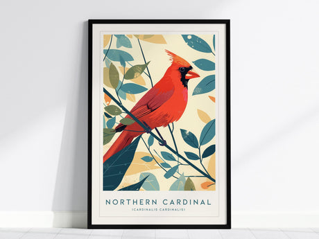 A framed poster of a Northern Cardinal features a bright red bird perched on a branch with stylized green and yellow leaves against a light background.