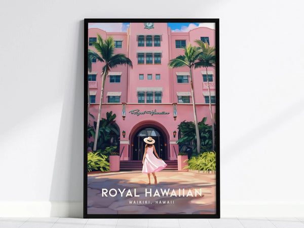 Framed poster of the Royal Hawaiian Hotel featuring pink Spanish-Moorish architecture, lush palm trees, and a woman in a white hat and dress walking towards the entrance.