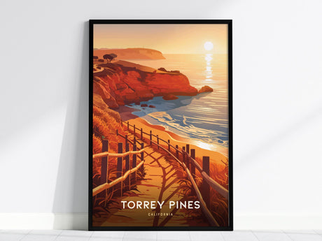 A framed poster of Torrey Pines, California, depicts a scenic coastal trail with orange sandstone cliffs, a winding path, and a setting sun reflecting on the ocean.