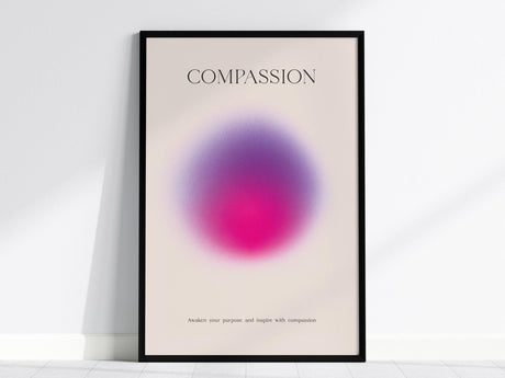 Framed poster featuring the word Compassion at the top with a vibrant pink and violet gradient in the center. Below, the text reads, “Awaken your purpose and inspire with compassion.”.