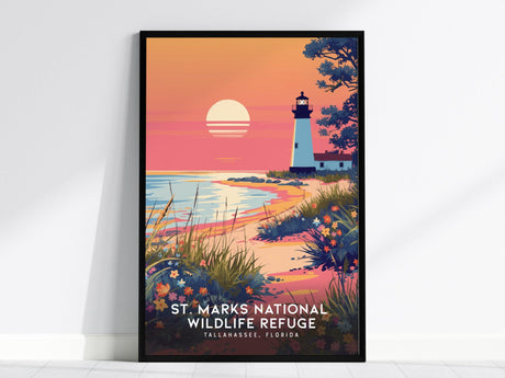 A framed poster depicts a sunset over a beach with a lighthouse, vibrant wildflowers, and coastal marshes, titled St. Marks National Wildlife Refuge, Tallahassee, Florida.