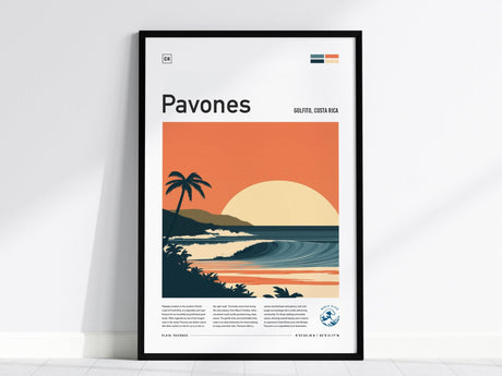 A framed poster featuring a stylized illustration of a sunset over a tropical ocean wave with palm trees and hills, labeled Pavones, Golfo Dulce, Costa Rica.