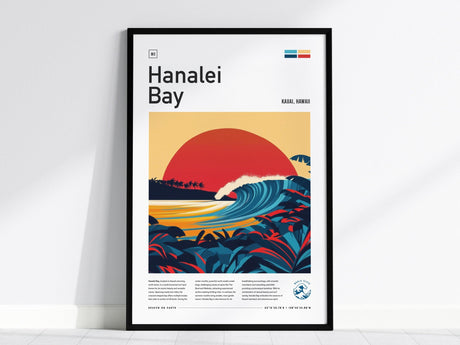 Framed poster of Hanalei Bay featuring a stylized red sunset over a curling wave, surrounded by tropical foliage, with text detail and minimalistic design elements.
