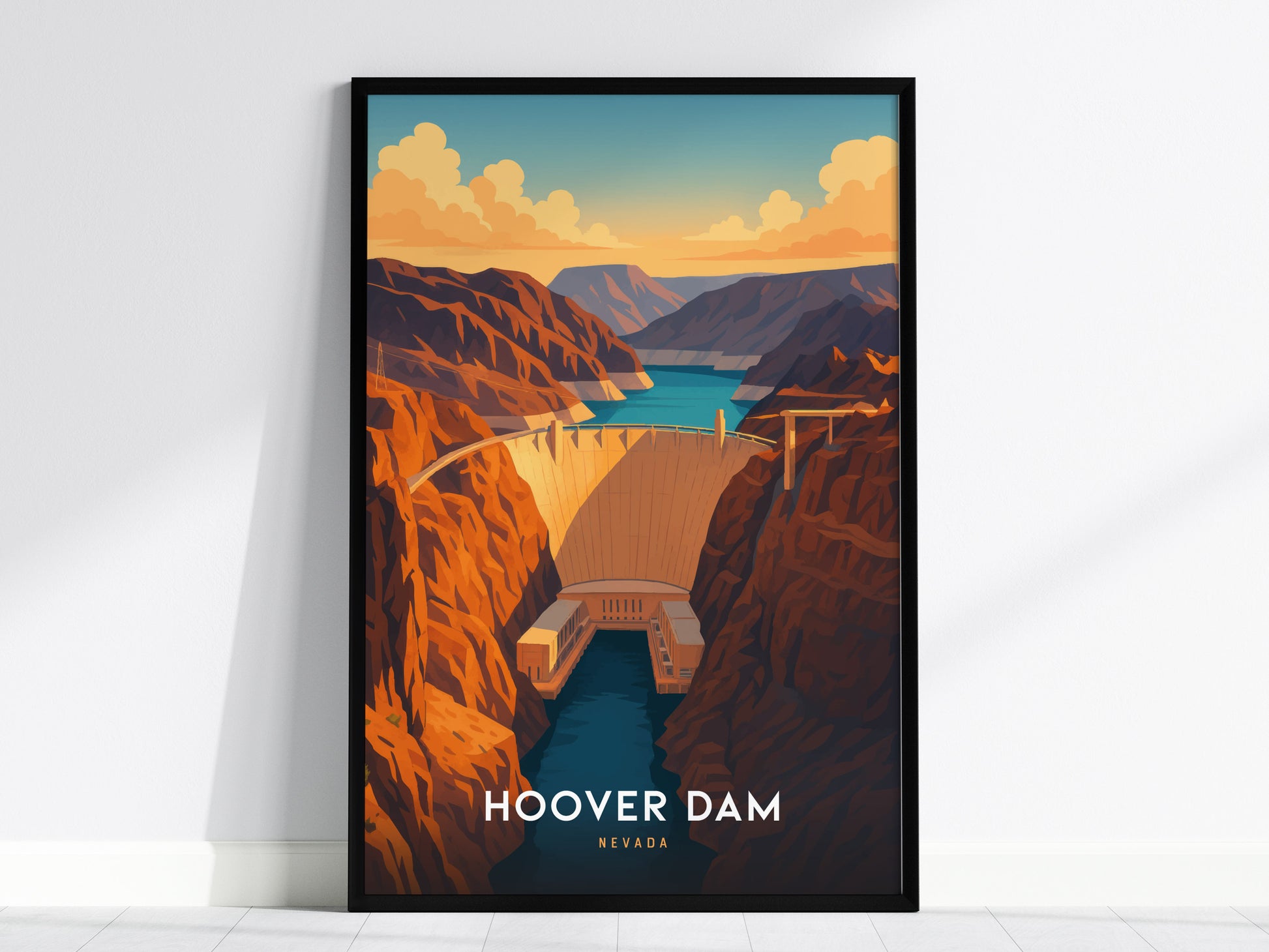 A framed illustration of the Hoover Dam is displayed against a white wall. The artwork features vibrant desert tones, layered canyon walls, and the calm blue waters of the Colorado River under a sky with scattered clouds.