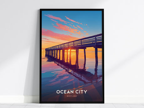 A framed poster of Ocean City, Maryland, features a sunset view of a boardwalk pier with vibrant orange and blue hues reflecting on the water.