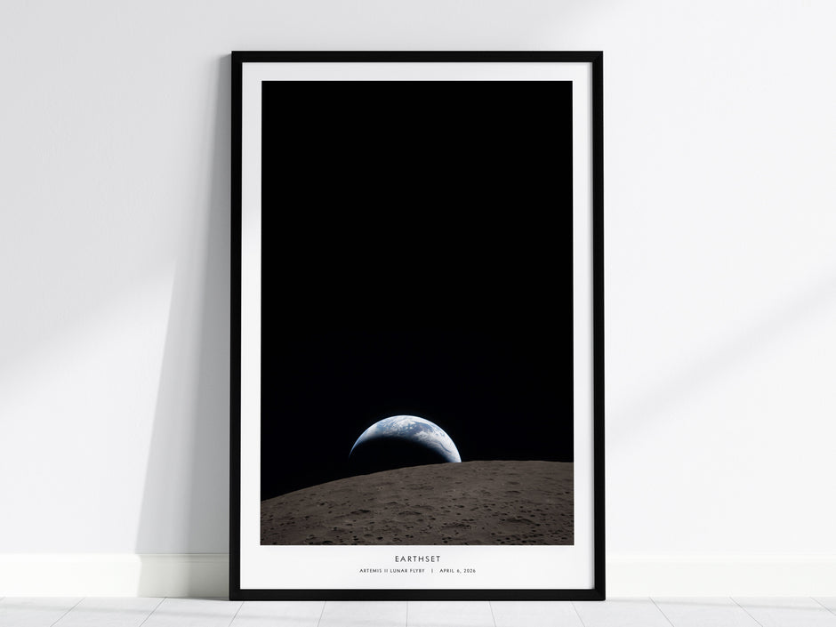 Framed Artemis II NASA poster titled "Earthset," showcasing Earth rising over the moon's gray surface with a black space backdrop.