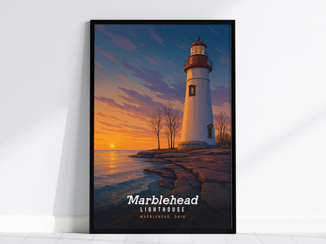 A framed poster depicts the Marblehead Lighthouse against a vibrant sunset sky, with the sun setting over Lake Erie. The lighthouse stands on a rocky shoreline, creating a striking piece of wall art.