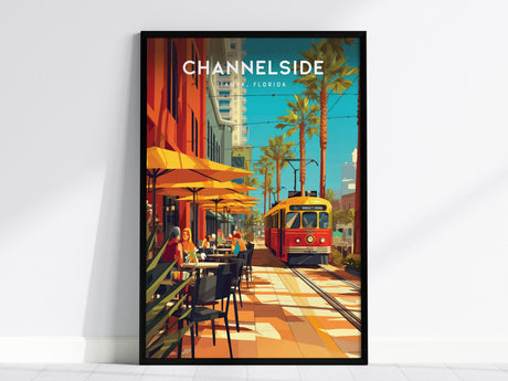 A vibrant poster of Channelside, Tampa, Florida, featuring a red trolley, palm trees, and people dining under yellow umbrellas along a sunny street.