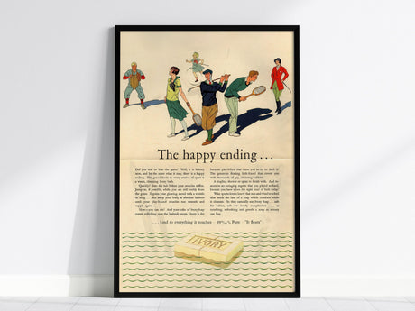 Framed vintage Ivory Soap advertisement featuring a 1920s illustration of people playing tennis, titled The Happy Ending, with a bar of Ivory soap depicted at the bottom.