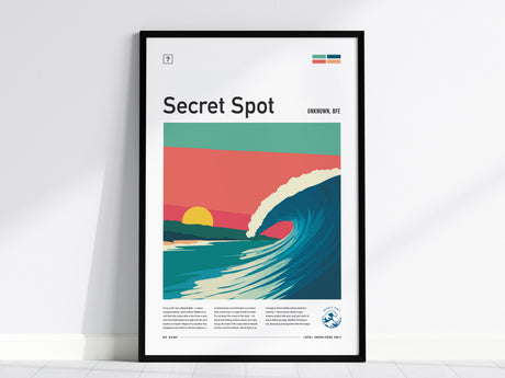 A framed poster titled Secret Spot features a vibrant illustration of a cresting wave under pastel skies, with a setting sun in the background. The design emphasizes surf culture and highlights the allure of hidden surf spots.