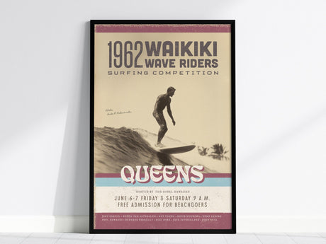 Framed vintage poster titled 1962 Waikiki Wave Riders Surfing Competition features a surfer riding a wave. Text includes event details and the word Queens in bold letters.
