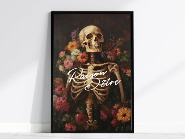 A framed poster features a skeleton surrounded by vibrant flowers with the French phrase Raison dÊtre in elegant script. The artwork blends gothic and botanical elements.