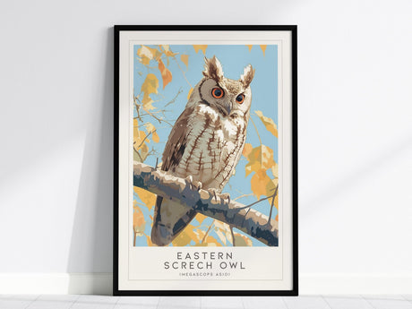 Framed poster of an Eastern Screech Owl perched on a branch with autumn leaves against a blue sky background. The owls orange eyes are prominently featured.