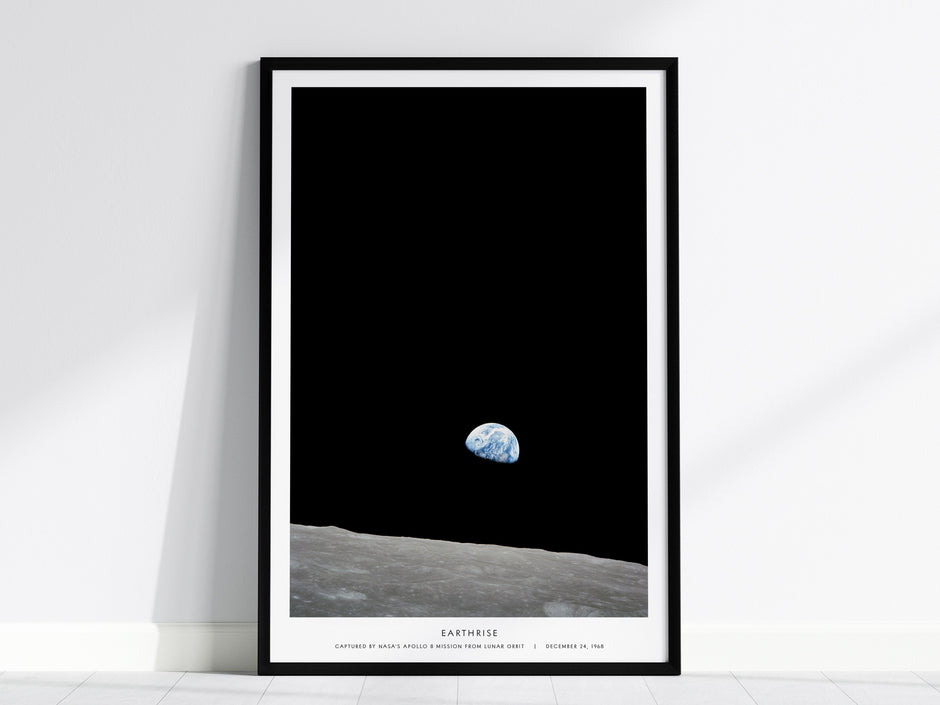 Framed Earthrise Apollo 8 wall art hanging on a white wall in a modern living room