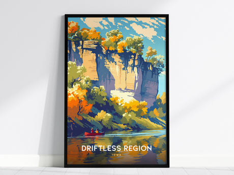 A framed poster depicting a vibrant fall landscape in the Driftless Region, Iowa, featuring towering limestone bluffs, colorful autumn foliage, and a red canoe on calm water. The sky is blue with scattered clouds.