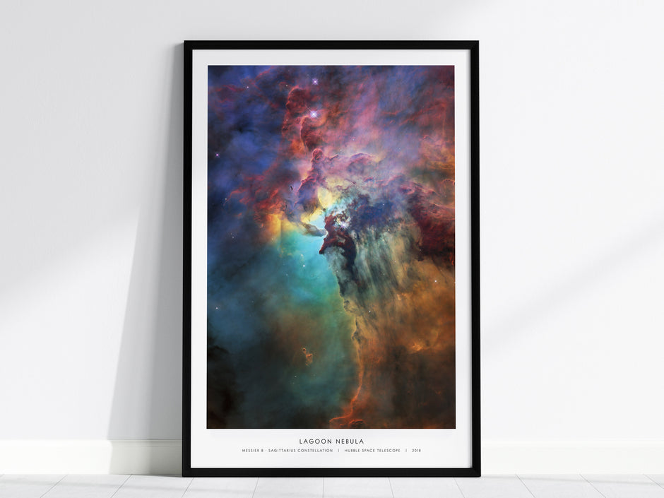 Vibrant Lagoon Nebula wall art print in a black frame, showcasing colorful interstellar clouds in the Sagittarius constellation.