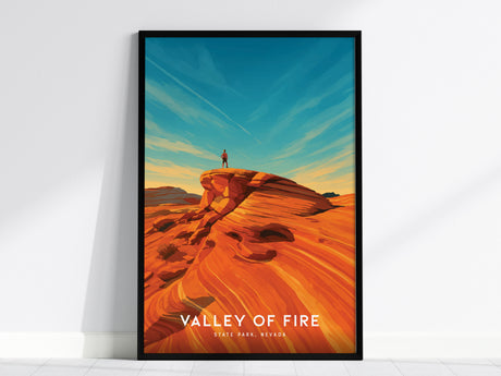 Framed vintage travel art poster of Valley of Fire, Nevada, showcasing vibrant red rock formations, a blue sky, and an adventurous figure.
