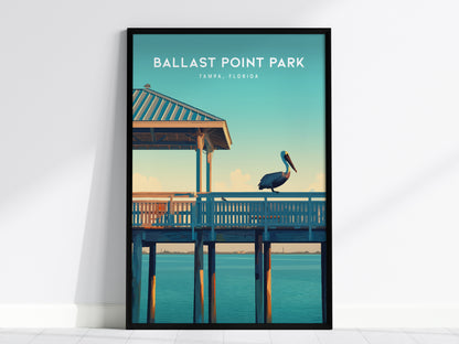 A framed poster of Ballast Point Park, Tampa, Florida, featuring a pelican perched on a wooden pier under a clear blue sky and calm water.