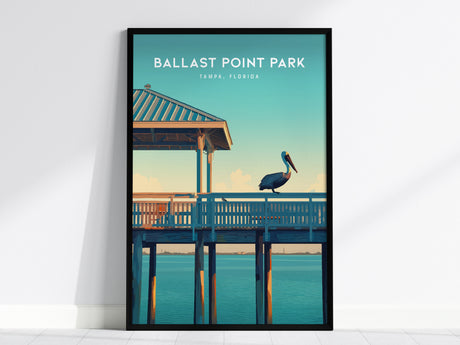 A framed poster of Ballast Point Park, Tampa, Florida, featuring a pelican perched on a wooden pier under a clear blue sky and calm water.