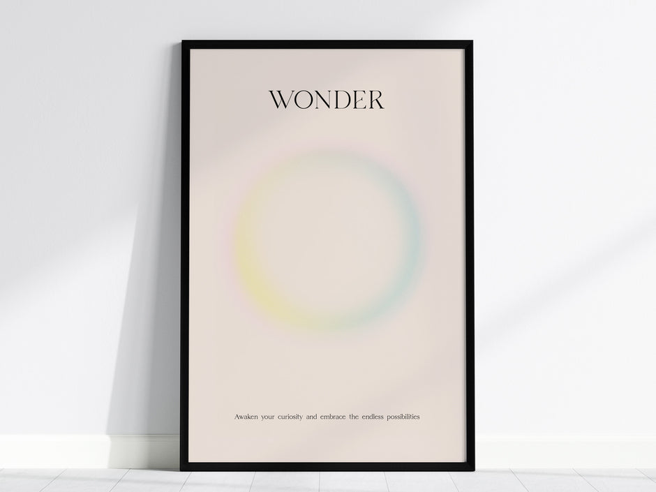 Framed WONDER wall art print featuring a pastel gradient design with soft pink, yellow, and blue hues, perfect for travel art décor.