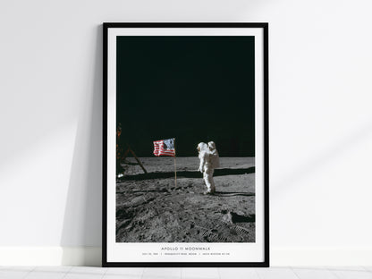 Apollo 11 moonwalk poster with Buzz Aldrin standing beside the American flag on the lunar surface