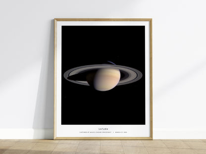 Framed poster of Saturn on a white wall