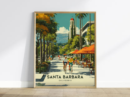 Framed artwork of Santa Barbara, California with people walking and riding bikes on a tree-lined street.