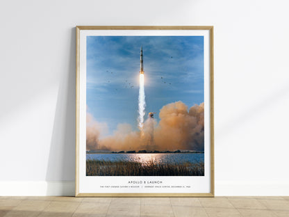 Framed Apollo 8 launch NASA wall art displayed on a white wall in a modern living room
