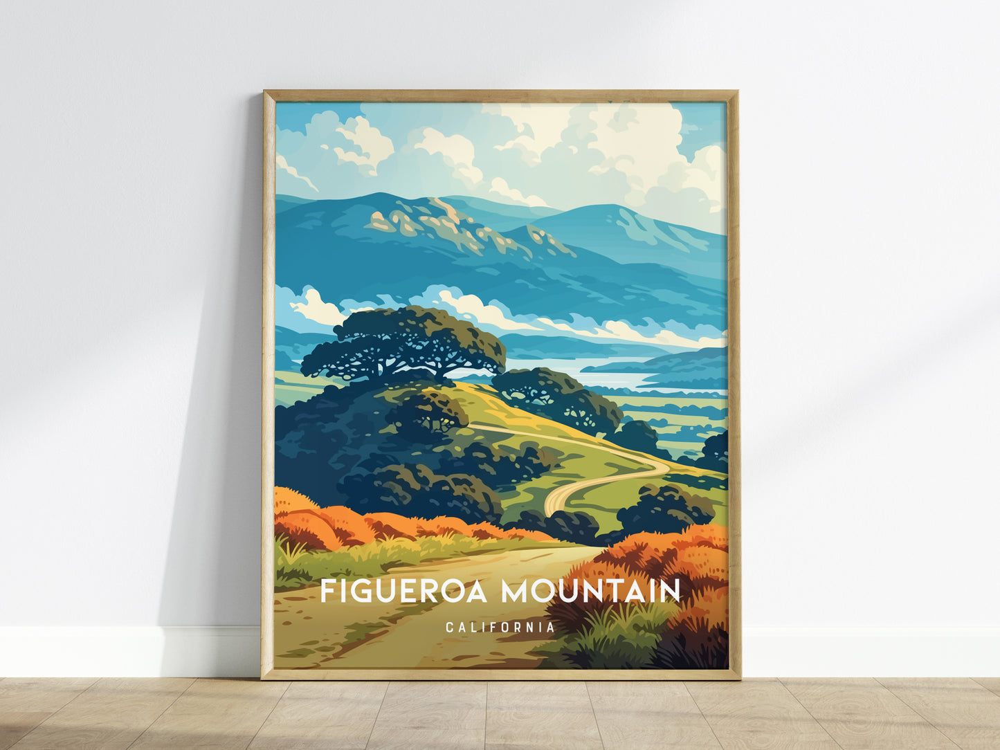 A framed poster of Figueroa Mountain in California showcases a vibrant landscape with rolling hills, lush greenery, and a backdrop of distant mountains under a bright blue sky.